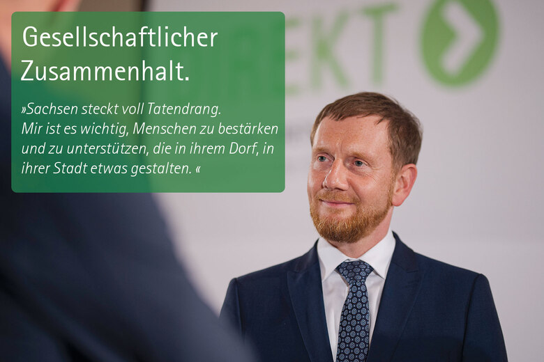 Ein Mann. Zitat: Gesellschaftlicher Zusammenhalt. »Sachsen steckt voll Tatendran. Mir ist wichtig, Menschen zu bestärken und zu unterstützen, die in ihrem Dorf, in ihrer Stadt etwas gestalten.«